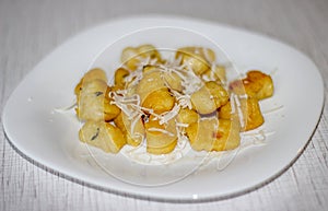 Italian dish. Potato gnocchi with shaved cheese