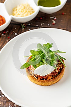 Italian dish Tortino di Verdure served on a white plate on wooden table