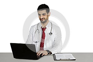 Italian doctor typing on the laptop computer