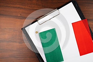 Italian document, mockup for text on clipboard, white sheet of paper in a folder for notes with Italian flag
