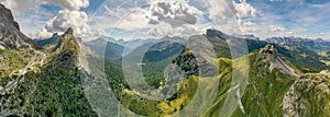 Italian Dolomite mountains valley. Aerial beautiful shot above the clouds.