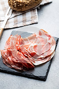 Italian dried ham. Coppa Stagionata, prosciutto and salami on cutting board