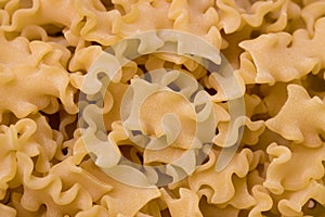 Italian dry pasta of the short mafalda type made with flour. For food background