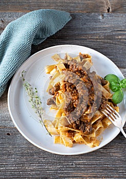 Italian duck ragout alla bolognese on a plate with pasta