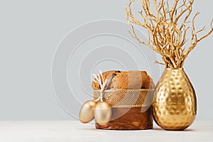 Italian Easter Panettone and golden eggs on table banner