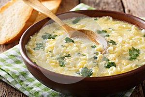 Italian egg cream soup stracciatella with farfalline pasta and c