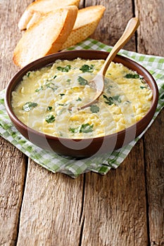 Italian egg soup stracciatella with farfalline pasta close-up. v