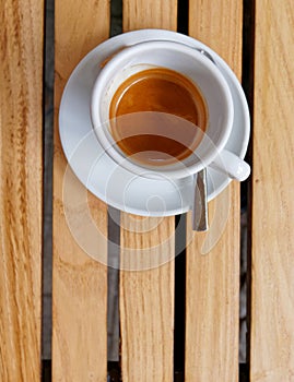 Italian espresso coffee cup top view on wooden stripes table background