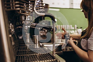 Italian espresso machine on a counter in a restaurant dispensing freshly brewed coffee