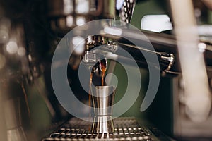 Italian espresso machine on a counter in a restaurant dispensing freshly brewed coffee