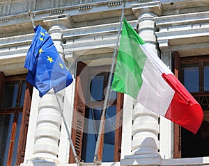 Italian and European flags a waving outside the historic palace