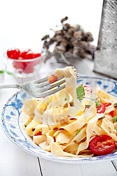 Italian fettuccine pasta with cherry tomatoes and parmesan