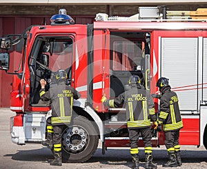 Italian firefighters climb on firetrucks during an emergency