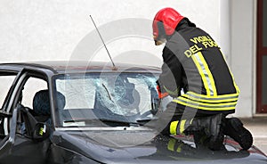Italian firemen break the windshield of the car to release the i