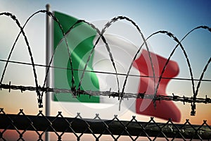 Italian flag behind barbed wire fence. Illegal immigration and security in Italy. 3D rendered illustration