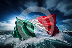 The Italian flag flutters powerfully against a dramatic ocean and sky backdrop