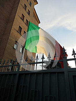 Italian flag over city houses