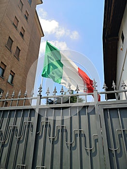 Italian flag over city houses