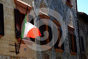 Italian flag and windows with brown window shutters
