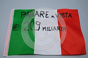 An Italian flag with written, pay on sight two hundred and nine billion euros, in Italian photo