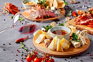 Italian food. Assortment of appetizers for a large company in a restaurant. Different types of smoked meat, sausages and cheeses.