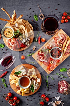 Italian food. Assortment of appetizers for a large company in a restaurant. Different types of smoked meat, sausages and cheeses.