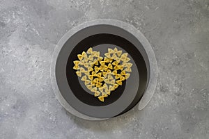 Italian Food background on stone table Top view. With heart shaped bowl