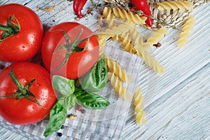 Italian food background with tomatoes, basil, pasta, olive oil,