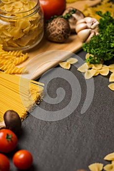Italian food concept. Pasta ingredients. Cherry-tomatoes, spaghetti pasta, rosemary and spices