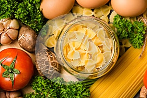 Italian food concept. Pasta ingredients. Cherry-tomatoes, spaghetti pasta, rosemary and spices