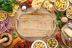Italian food. Culinary concept background with ingredients for cooking on wooden kitchen rustic table, top view with copy space.