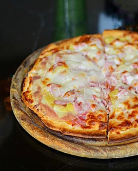 Italian food. Delicious pizza and served on wooden platter with, close up view.
