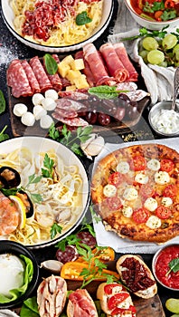 Italian food dishes on dark background