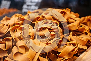 Italian food, dried handmade colorful pasta pappardelle with saffron, ready to cook, Milan, Lombardy, Italy photo