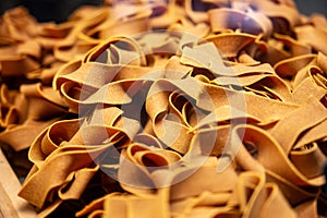 Italian food, dried handmade colorful pasta pappardelle with saffron, ready to cook, Milan, Lombardy, Italy photo