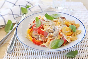 Italian food. Farfalle pasta with mushrooms, bell pepper, cheese and basil