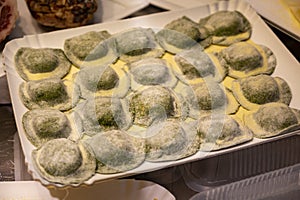 Italian food, fresh home made stuffed pasta tortelli or ravioli dumplings ready to cook, Parma, Emilia Romagna, Italy