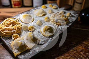 Italian food, fresh home made stuffed pasta tortelli or ravioli dumplings ready to cook, Parma, Emilia Romagna, Italy photo