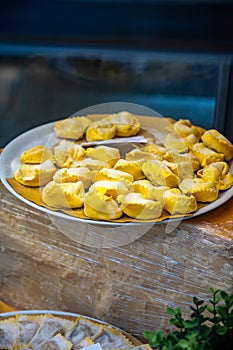 Italian food, fresh homemade stuffed pasta tortelli or ravioli dumplings ready to cook, Milan, Lombardy, Italy photo