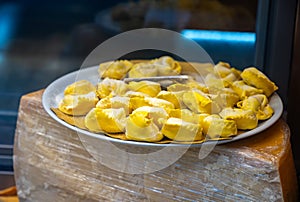 Italian food, fresh homemade stuffed pasta tortelli or ravioli dumplings ready to cook, Milan, Lombardy, Italy photo