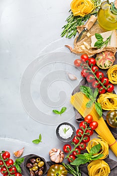 Italian food ingredients with pasta, tomatoes, cheese, olive oil, basil