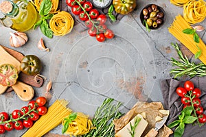 Italian food ingredients with pasta, tomatoes, cheese, olive oil, basil