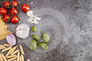 Italian food ingredients. Vegetables, pasta on dark background. Italian cuisine