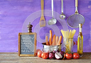 Italian food, ingredients for vegetarian spaghetti dish and kitchen utensils, panorama,copy space