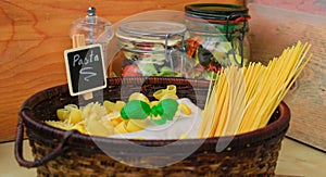 Italian food,Mixed dried pasta selection in basket with basil