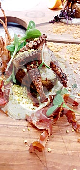 Italian food Octopus with potato and speck