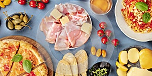 Italian food panorama. Pizza, pasta, cheese, ham, capers, wine, tomatoe etc