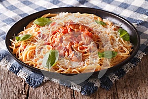 Italian food: pasta with Amatriciana Sauce and basil close-up.