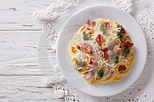 Italian food: pasta carbonara on the table. horizontal top view