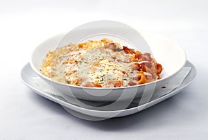 Italian food with pasta, cheese and tomatoes sauce